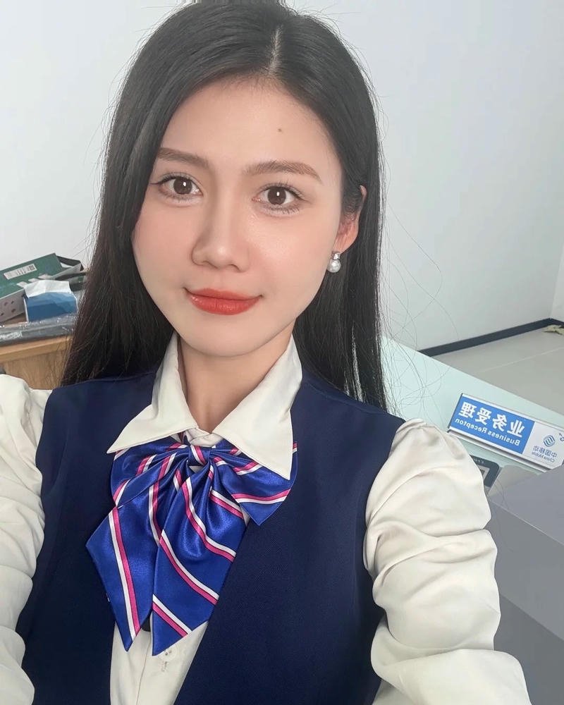 Ảnh gái văn phòng mặc đồng phục xanh nơ cổ cười tươi tắn